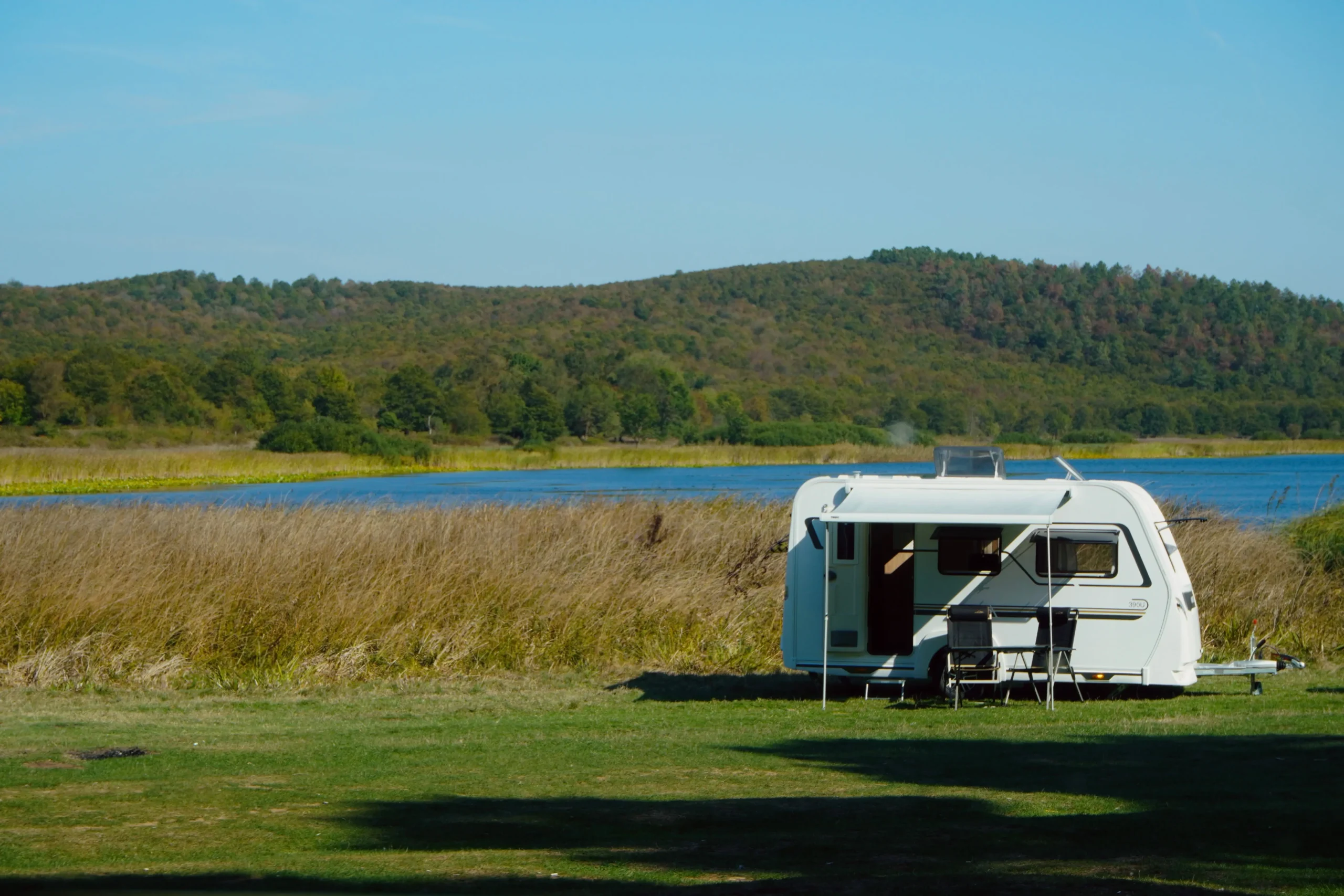 Family enjoying cheap caravan hire at a coastal holiday park in Australia with a modern caravan rental setup.